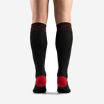 Close-up of red diamond geometric trim detail at the cuff of custom red and black soccer socks
