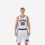 Custom red white and blue basketball uniforms showing full front and back of white jersey with navy side panels and red trim plus matching shorts