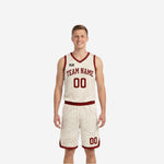 Front view of custom red and white reversible basketball uniform with arched team name, number 00, and cream-white armhole binding on maroon-red jersey