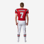 Back view of custom youth football uniform set in red and white showing player nameplate, back number, and vertical red and black pant side stripe