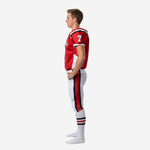 Opposite side view of custom red and white youth football uniform set showing sublimated side panel detail and pant stripe from hip to knee