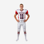 Custom red and white youth football uniforms front view showing white jersey with red shoulder panels, navy trim V-neck collar, front team name and number 11, and matching white pants with red and navy side stripe