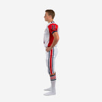 Opposite side view of red and white custom youth american football uniforms showing jersey tuck length, pant stripe detail running hip to knee, and drawstring waistband at the front pant panel