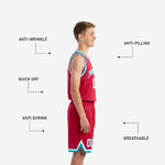 Opposite side view of red and teal youth basketball uniform showing dot-burst sublimation pattern on lower shorts leg panel