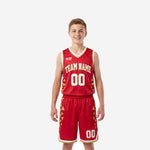 Custom red youth basketball uniforms with gold triangle side panels, white V-neck binding, and matching shorts - front and back full set view