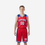 Red youth basketball uniforms with royal blue geometric side panels and white V-neck binding, arched team name and number 00 on jersey and matching shorts, front view