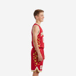 Red youth basketball uniform set front view showing arced team name in gold, front number, and matching red and gold shorts on a youth boy model