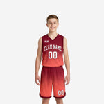 Front view of red youth basketball uniforms with maroon-to-coral gradient jersey and matching shorts, team name and number 00 on chest
