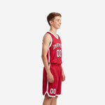 Side view of custom red and white youth basketball uniform set showing V-neck jersey with white armhole binding and red shorts with white hem trim
