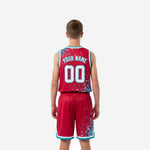 Side view of red youth basketball uniform set showing teal armhole binding, elastic waistband with drawcord, and teal V-notch hem on shorts