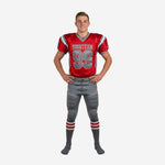 Custom red youth football uniforms full front view showing red jersey with grey side panels, team name, number 99, and matching grey football pants with red stripe