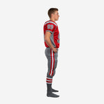 Side view of custom red youth football uniforms showing red jersey with grey binding, sleeve number on shoulder panel, and grey football pants with red and white double side stripe
