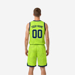 Lime green side view of reversible basketball jersey and shorts showing navy armhole binding and matching contour-line pattern on shorts