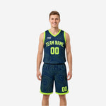 Reversible basketball jersey and shorts in navy with lime green topographic contour pattern and lime green V-neck binding, front view on male model