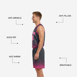 Pink and charcoal reversible basketball uniform side view showing armhole binding, side panel, and shorts waistband construction