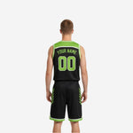 Side view of the black and lime green reversible basketball jersey showing diagonal slash accent panels and white V-neck binding trim