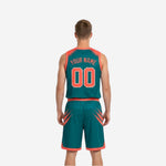 Front view of teal and orange reversible basketball uniform set with arched team name and front number on the jersey chest