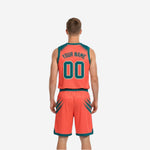 Left side view of teal and orange reversible basketball jersey showing orange armhole binding and diagonal slash shoulder design