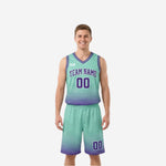 Front view of the teal side of purple and teal reversible high school basketball uniforms showing arced team name in purple and number 00 on matching shorts