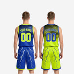 Full two-piece reversible basketball uniform set in royal blue and neon yellow-green laid flat showing both jersey and shorts