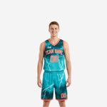 Custom reversible team basketball uniforms in teal and orange lightning design with matching shorts - front view of full set