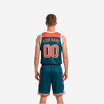 Teal reversible basketball jersey and shorts side view showing coral-orange side panel trim and cream armhole binding