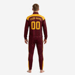 Close detail of maroon custom soccer tracksuit jacket with stand collar, full-zip front, and sublimated team logo on chest