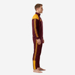Left side view of maroon and gold custom soccer tracksuit showing full-length gold stripes on sleeve and pant leg