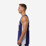 Left side view of navy basketball jersey showing white mesh side panel and gold armhole binding detail