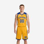 Gold side of custom royal blue and gold reversible basketball uniforms with blue team name, number 00, and chevron panels on gold jersey and shorts worn by male model