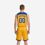 Left side view of mens reversible basketball uniforms in royal blue and gold showing diagonal stripe detail on jersey and shorts panel
