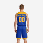 Side view of royal blue and gold reversible basketball uniform showing chevron panel detail on jersey and shorts right side