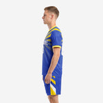 Right side profile of custom blue and gold soccer uniform with stripe sleeve cuffs and matching shorts