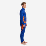 Royal blue custom soccer tracksuit with orange splash print - left side view showing tapered pant leg and stand collar jacket
