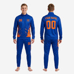 Royal blue tapered track pants with orange splash sublimation print - custom soccer tracksuit bottoms with player number on leg
