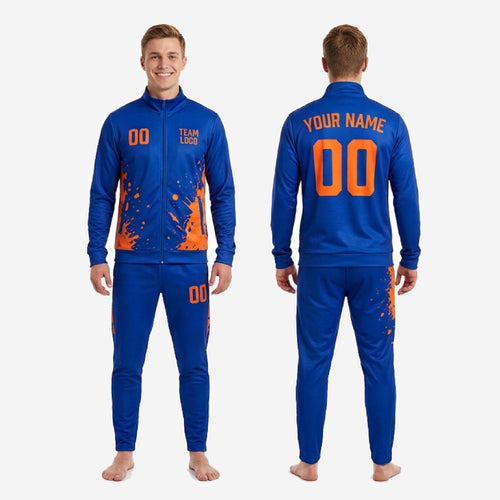 Royal blue tapered track pants with orange splash sublimation print - custom soccer tracksuit bottoms with player number on leg