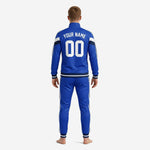 Full 2-piece royal blue soccer tracksuit set with white double stripes and navy contrast cuffs worn by adult male model