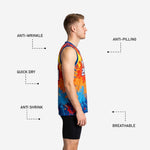 Close detail of paint-splash sublimation print on royal blue basketball jersey showing orange, red, and yellow splash pattern with white team name lettering