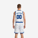 Opposite side view of royal blue and white reversible basketball uniform showing shorts side panel trim and jersey silhouette