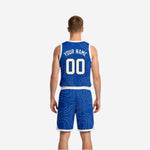 Side view of custom royal blue and white reversible basketball uniform set showing armhole binding and side panel construction detail