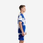Custom blue and white soccer uniform side view showing Royal Blue splash pattern across jersey and shorts