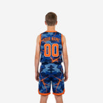 Side view of royal blue and orange camo youth basketball jersey and shorts set showing orange side panel stripe and waistband