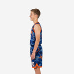 Custom royal blue youth basketball uniform camo jersey with orange armhole binding and matching shorts, front side view