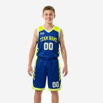 Royal blue youth basketball uniforms full two-piece set with neon yellow-green chevron side panels and arched team name on royal blue jersey front