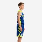 Front view of royal blue youth basketball uniform with neon yellow-green shoulder panels, arched team name, and matching shorts with double hem stripe
