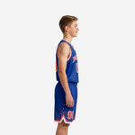 Custom royal blue youth basketball uniform front view showing arched team name and number 00 on royal blue jersey with red and white V-neck binding