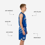 Close detail of royal blue youth basketball shorts showing diagonal slash sublimation, drawcord waistband, and white hem band with navy edge