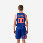 Left side view of royal blue kids basketball uniform showing elastic drawcord waistband on shorts and dot-burst pattern climbing the leg panels