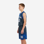 Side view of royal blue youth basketball uniform showing armhole binding, jersey length, and shorts gradient pattern