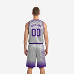 Side view of the silver-gray reversible basketball uniform showing purple V-neck trim, hexagon side panels, and purple waistband on matching shorts